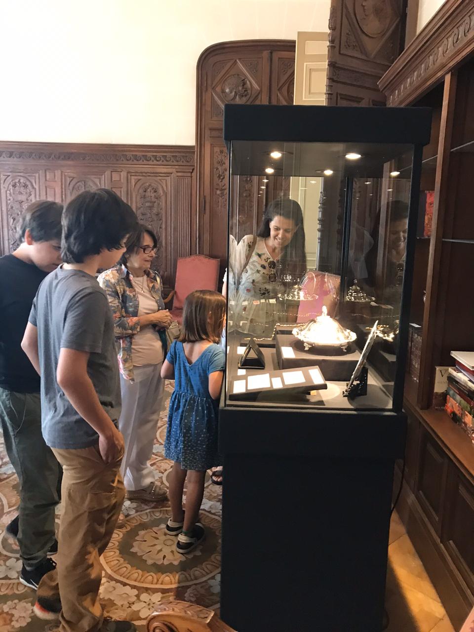 Color photograph, group of people looking at a display case