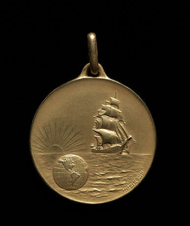 Color photograph, round gold colored medal with sailing ship and globe showing the western hemisphere