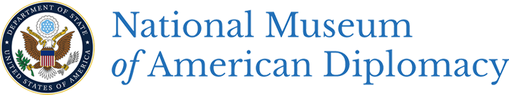 Logo of the National Museum of American Diplomacy, with the seal of the United States set within a blue circle inscribed with "Department of State (/) United States of America" in white lettering to the left and lettering for the museum in a royal blue on white background