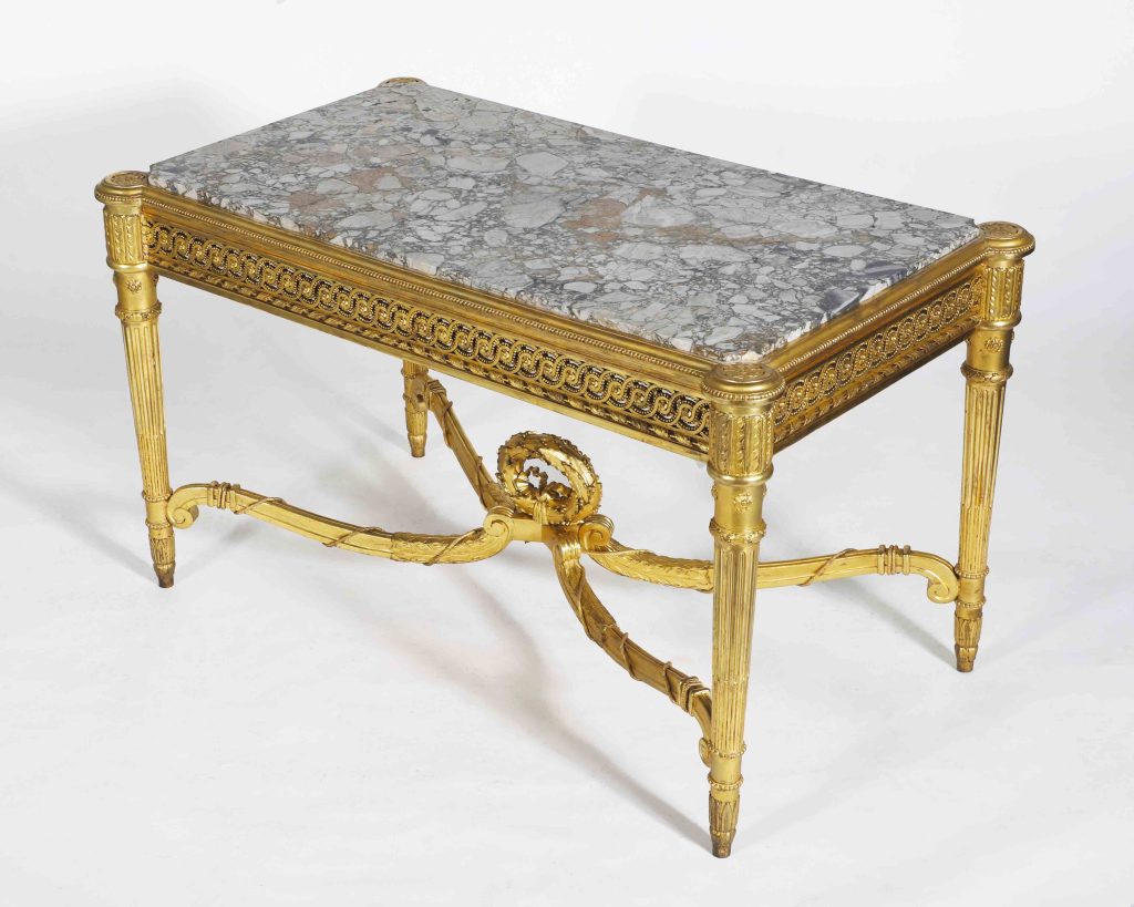 Gilded gesso marble topped table with Guilloche frieze, on turned tapering legs&nbsp;&nbsp;
circa late 19th century&nbsp;&nbsp;
U.S. Embassy, Buenos Aires, Argentina&nbsp;


When President Herbert Hoover visited Buenos Aires on a goodwill tour of Latin America in 1928, U.S. Ambassador to Argentina Robert Woods Bliss, tired of living in hotels and rented homes, secured Hoover’s approval to seek a permanent ambassadorial residence. Bliss and his wife Mildred, the proprietors of Dumbarton Oaks in Washington D.C., set their sights on&nbsp;acquiring&nbsp;the magnificent&nbsp;Palacio Bosch, a masterpiece of French classicism. They succeeded in convincing the stately home’s owner and builder, Argentine Foreign Minister Ernesto Bosch, to sell it to the U.S. Government.&nbsp;&nbsp;
&nbsp;&nbsp;
Many original furnishings of the Bosch Palace conveyed with the sale,&nbsp;perhaps including&nbsp;this oblong Brescia marble top table. Ernesto Bosch had once been Argentina’s ambassador to France, so it is&nbsp;possible Bosch&nbsp;purchased&nbsp;the table while in Paris.&nbsp;&nbsp;
Whether the elegant table conveyed with the house or was&nbsp;purchased&nbsp;by the wealthy Blisses, it continues to adorn Palacio Bosch’s graceful Music Room, the setting for innumerable diplomatic gatherings over the last century.&nbsp;
